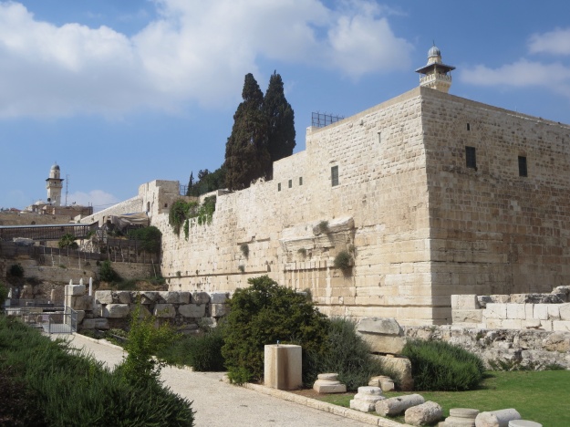 A view of the south-west corner of the Temple platform wall.  The street running along the western wall was the Main Street of Jerusalem,  with money changers and shops on either side, selling animals for sacrifice in the Temple as well as household goods.  It was the place where people gathered in great numbers to buy and sell, to greet and meet, to pass the time of day.   It is here that in later years, with some discontent about the Hellenic culture overriding the ancient faith and customs of the Israelite ancestors, that the rabbis gathered to teach the people and to gather followers.  It is likely that Jesus also may have addressed the crowds here. It seems that the money changers and shopkeepers must have  encroached onto the Temple platform itself, for the Gospels record that Jesus overturned the tables of the money changers and of those who were selling doves, sheep and cattle!  cf. Mt 21:11-13, Mk 11:14-16, Jn 2:14-16.